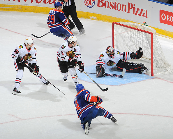 EDMONTON, AB - NOVEMBER 18: Corey Crawford #50 of the Chicago Blackhawks makes a big save in overtime on a shot from Taylor Hall #4 of the Edmonton Oilers on November 18, 2015 at Rexall Place in Edmonton, Alberta, Canada. (Photo by Andy Devlin/NHLI via Getty Images)