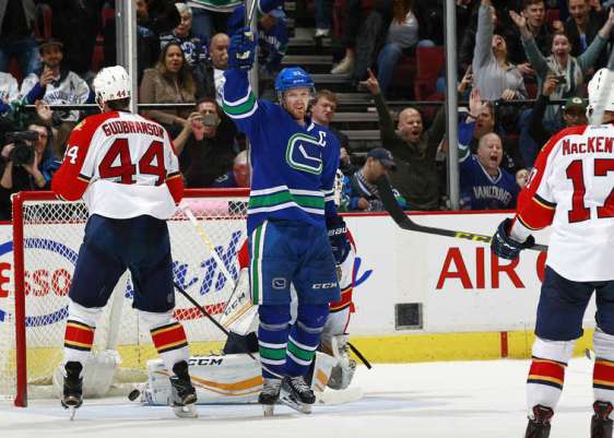 VANCOUVER, BC - JANUARY 11: Henrik Sedin #33 of the Vancouver Canucks celebrates after Daniel Sedin scores in overtime on Roberto Luongo #1 of the Florida Panthers as Erik Gudbranson #44 of the Panthers watches during their NHL game at Rogers Arena January 11, 2016 in Vancouver, British Columbia, Canada. Vancouver won 3-2. (Photo by Jeff Vinnick/NHLI via Getty Images)