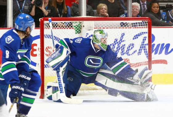 VANCOUVER, BC - JANUARY 11: Christopher Tanev #8 of the Vancouver Canucks turns to watch Jacob Markstrom #25 of the Canucks make a save against the Florida Panthers during their NHL game at Rogers Arena January 11, 2016 in Vancouver, British Columbia, Canada. Vancouver won 3-2. (Photo by Jeff Vinnick/NHLI via Getty Images)