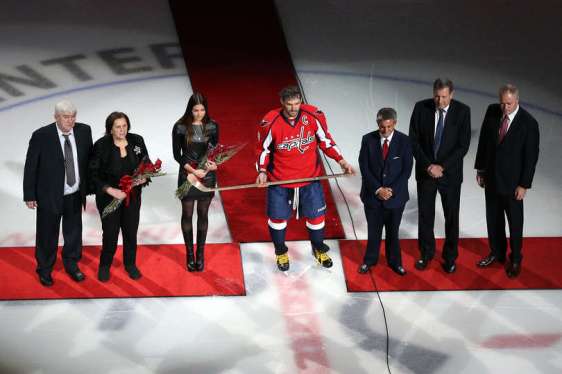 WASHINGTON, DC - JANUARY 14: Alex Ovechkin #8 of the Washington Capitals is poses after being presented a commemorative hockey stick by Washington Capitals owner Ted Leonsis in honor of his 500th career NHL goal before playing the Vancouver Canucks at Verizon Center on January 14, 2016 in Washington, DC. (Photo by Patrick Smith/Getty Images)