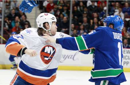 VANCOUVER, BC - MARCH 1: Matt Martin #17 of the New York Islanders and Derek Dorsett #15 of the Vancouver Canucks fight during their NHL game at Rogers Arena March 1, 2016 in Vancouver, British Columbia, Canada. (Photo by Jeff Vinnick/NHLI via Getty Images)
