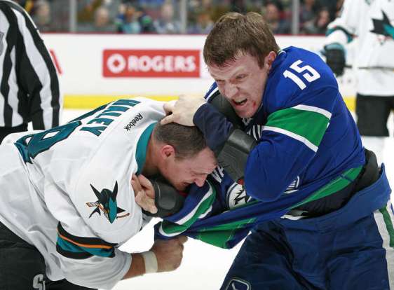VANCOUVER, BC - MARCH 3: Derek Dorsett #15 of the Vancouver Canucks and Micheal Haley #38 of the San Jose Sharks fight during their NHL game at Rogers Arena March 3, 2016 in Vancouver, British Columbia, Canada. (Photo by Jeff Vinnick/NHLI via Getty Images)