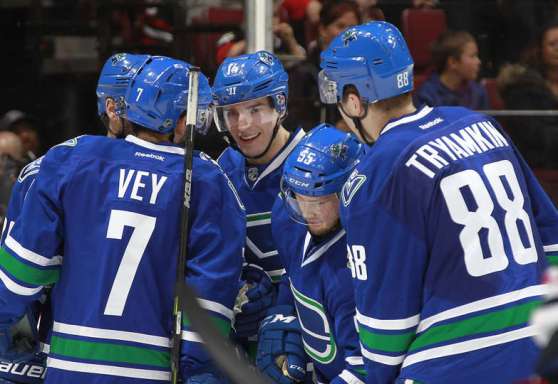 VANCOUVER, BC - MARCH 27: Alexandre Burrows #14 of the Vancouver Canucks is congratulated after scoring against the Chicago Blackhawks during their NHL game at Rogers Arena March 27, 2016 in Vancouver, British Columbia, Canada. (Photo by Jeff Vinnick/NHLI via Getty Images)