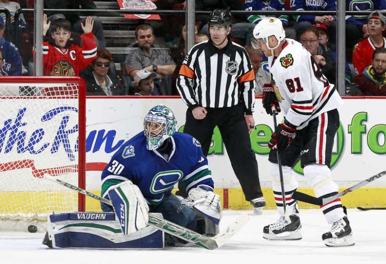 VANCOUVER, BC - MARCH 27: Marian Hossa #81 of the Chicago Blackhawks watches as a shot by Andrew Ladd #16 beats Ryan Miller #30 of the Vancouver Canucks for a goal during their NHL game at Rogers Arena March 27, 2016 in Vancouver, British Columbia, Canada. Chicago won 3-2. (Photo by Jeff Vinnick/NHLI via Getty Images)