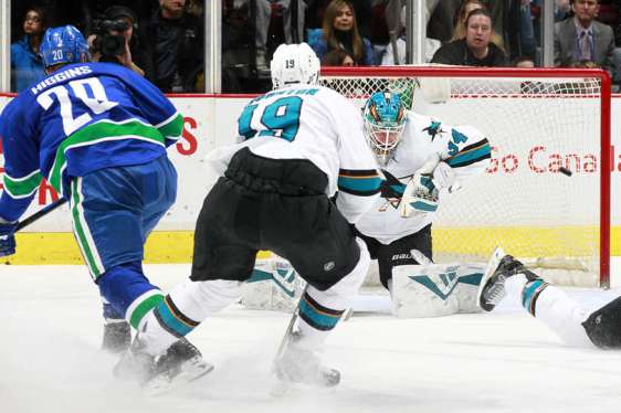 VANCOUVER, BC - MARCH 29: Chris Higgins #20 of the Vancouver Canucks beats James Reimer #34 of the San Jose Sharks for a shorthanded goal during their NHL game at Rogers Arena March 29, 2016 in Vancouver, British Columbia, Canada. (Photo by Jeff Vinnick/NHLI via Getty Images)