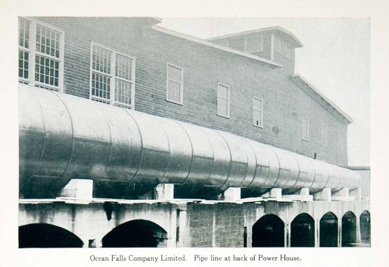 original 1915 duotone halftone print of the pipe line and power house in Ocean Falls, British Columbia, Canada. Ocean Falls used to be a company town with its residents working in the pulp and paper mill.