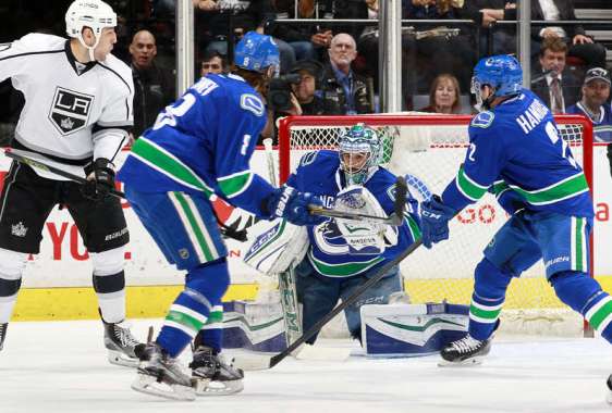 Los Angeles Kings vs. Vancouver Canucks VANCOUVER, BC - APRIL 4: Milan Lucic #17 of the Los Angeles Kings, Christopher Tanev #8 and Dan Hamhuis #2 watch Ryan Miller #30 of the Vancouver Canucks make a save during their NHL game at Rogers Arena April 4, 2016 in Vancouver, British Columbia, Canada. (Photo by Jeff Vinnick/NHLI via Getty Images)