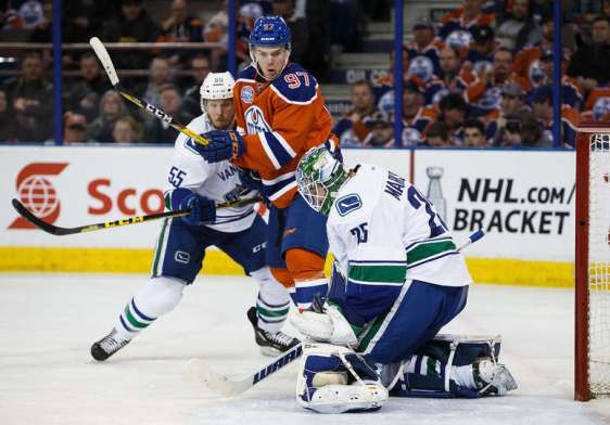 EDMONTON, AB - APRIL 6: Connor McDavid #97 of the Edmonton Oilers can't get a shot past goaltender Jacob Markstrom #25 of the Vancouver Canucks on April 6, 2016 at Rexall Place in Edmonton, Alberta, Canada. The game is the final game the Oilers will play at Rexall Place before moving to Rogers Place next season. (Photo by Codie McLachlan/Getty Images)